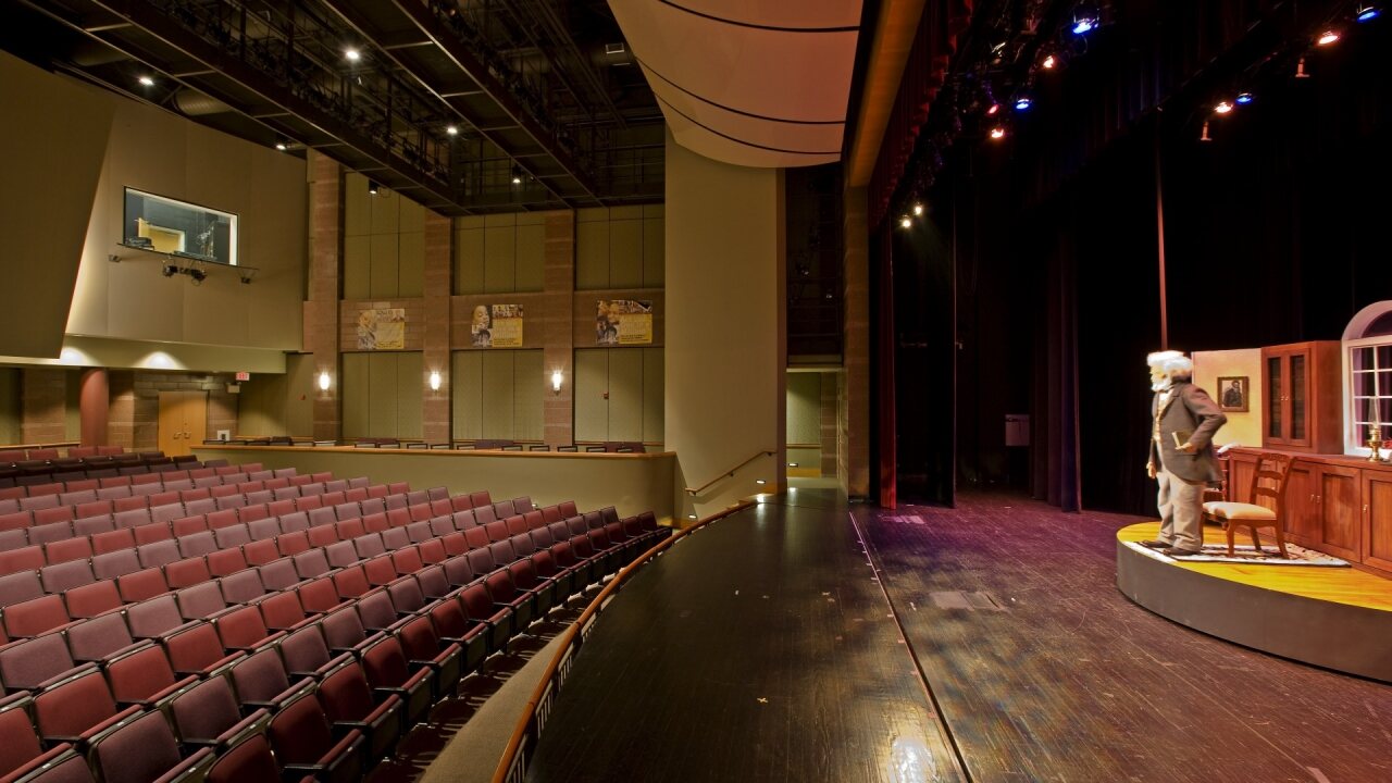 side photo of a stage and theatre seating.