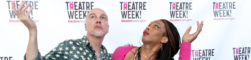 white man in green spotted shirt and black woman in red and pink in front of a white backdrop reading theatre week