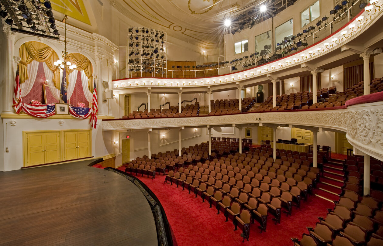 view of auditorium with red seats from the side of the stage
