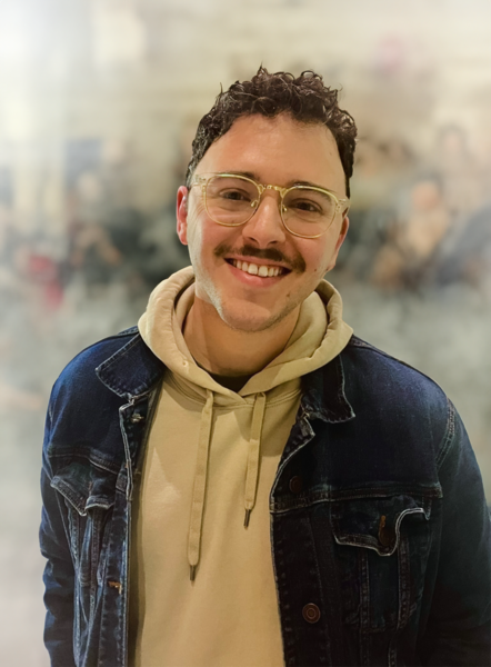 blake waters, man with tan hoodie, denim jacket, glasses and a mustache