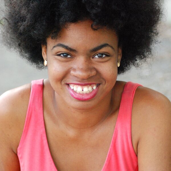 "Black woman with afro smiling"